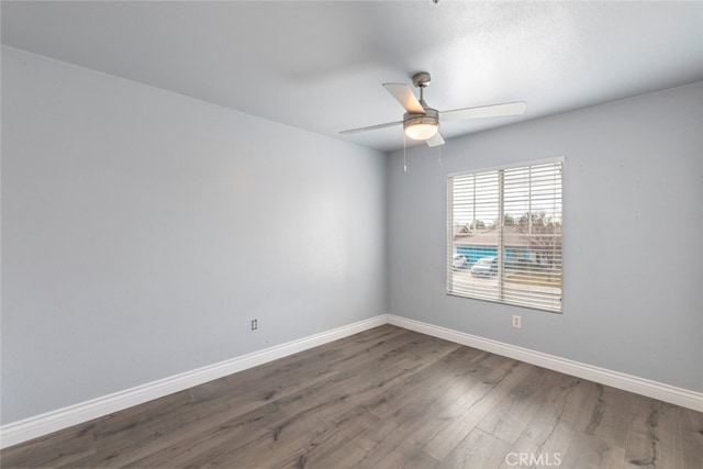 unfurnished room with ceiling fan and dark hardwood / wood-style floors