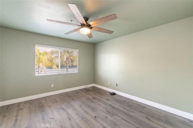 spare room with wood-type flooring and ceiling fan