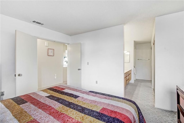 carpeted bedroom with ensuite bathroom