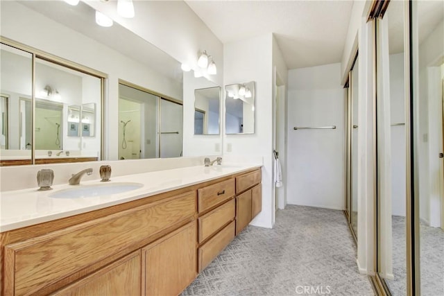 bathroom with walk in shower and vanity