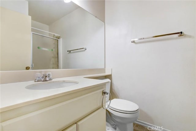 bathroom with vanity, toilet, tile patterned floors, and a shower with shower door