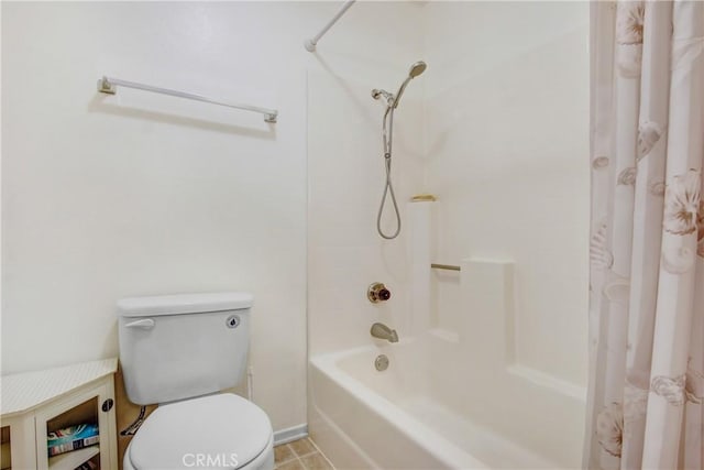 bathroom featuring tile patterned floors, toilet, and shower / bath combo with shower curtain