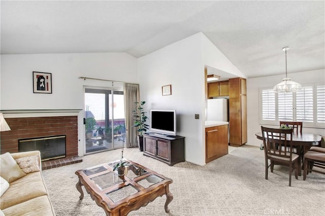 living room with lofted ceiling, light carpet, a chandelier, and a healthy amount of sunlight