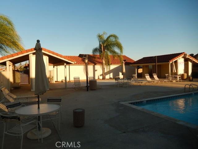 back of house with a patio and a community pool