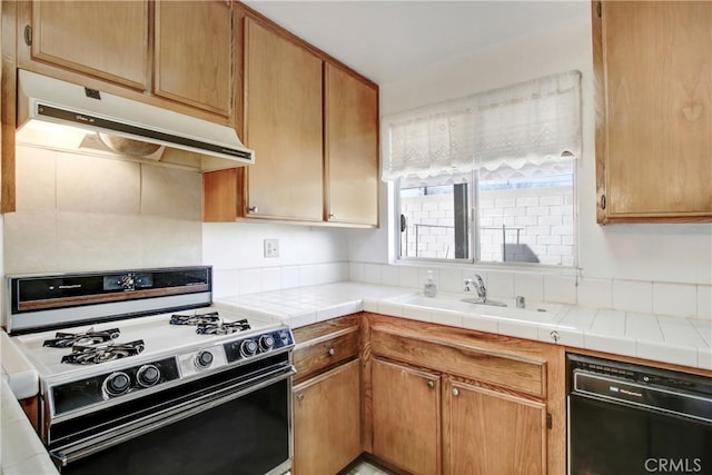 kitchen with sink, white gas range, black dishwasher, and tile countertops