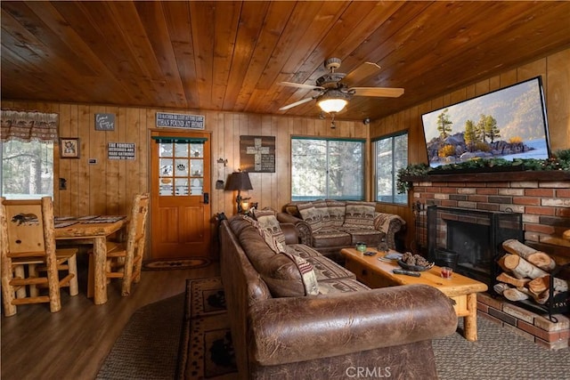 living room with wood walls, wood ceiling, a brick fireplace, ceiling fan, and hardwood / wood-style floors