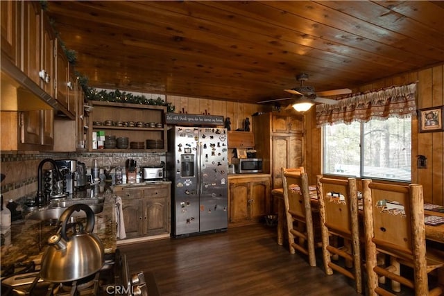 kitchen featuring sink, wood ceiling, wooden walls, stainless steel appliances, and dark hardwood / wood-style floors