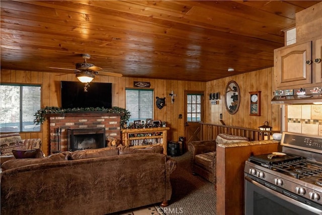 carpeted living room featuring wooden ceiling and wood walls