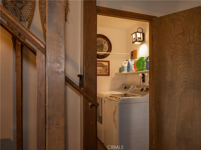 clothes washing area featuring separate washer and dryer