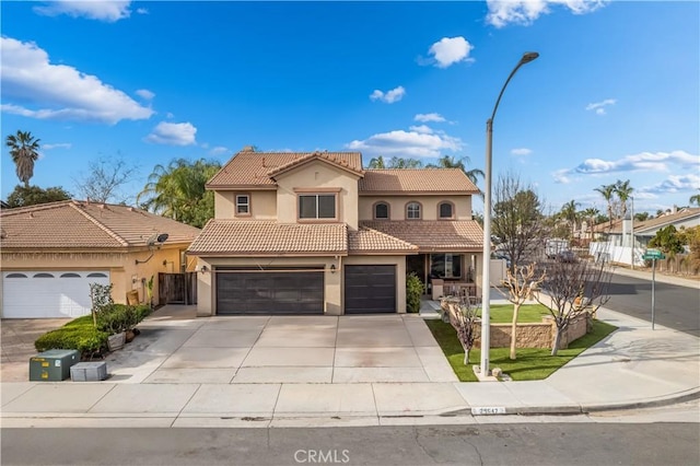 mediterranean / spanish-style home with a garage