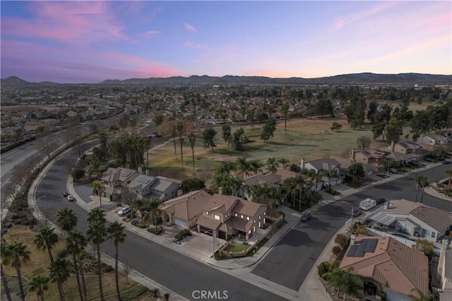 aerial view at dusk featuring a mountain view