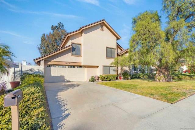 view of property featuring a garage and a front yard