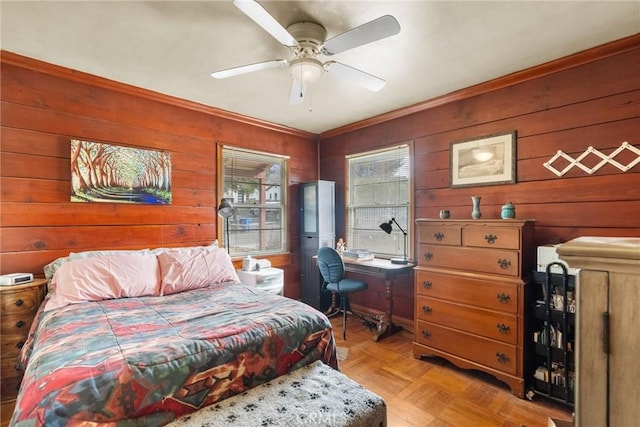 bedroom featuring ceiling fan, multiple windows, and light parquet floors