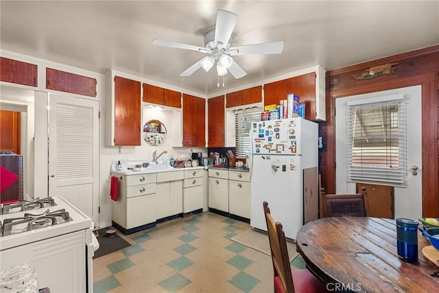 kitchen with ceiling fan, white appliances, and sink