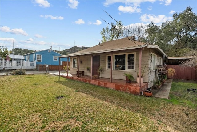 back of house featuring a yard and a patio