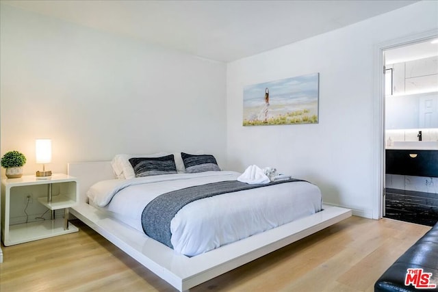 bedroom with light hardwood / wood-style flooring