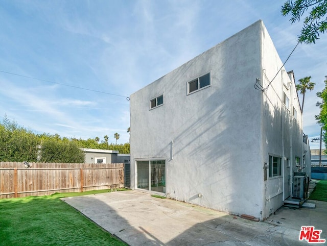 back of property with a patio and a lawn