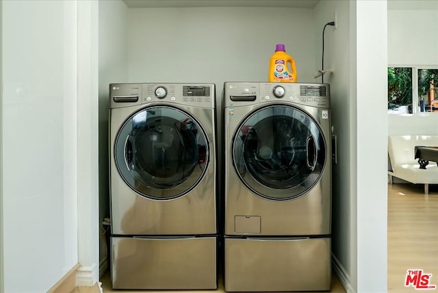 laundry room featuring light hardwood / wood-style flooring and washer and dryer