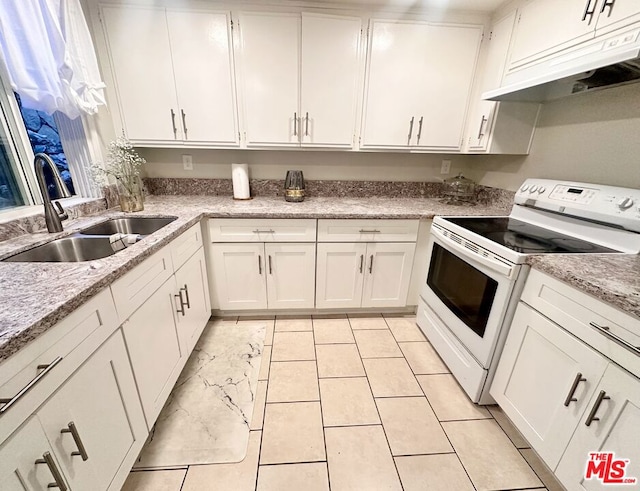 kitchen with light stone countertops, sink, white electric range, and white cabinets