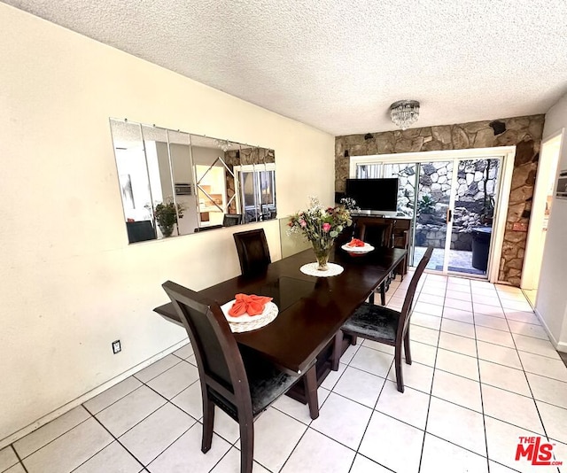 dining space with tile patterned flooring and a textured ceiling