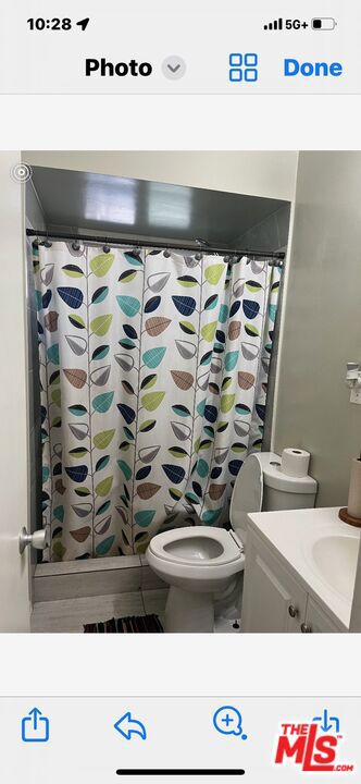 bathroom with vanity, toilet, and a shower with shower curtain