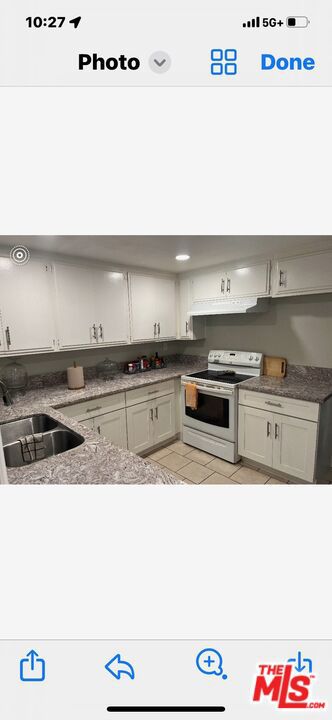 kitchen featuring sink and white electric range oven