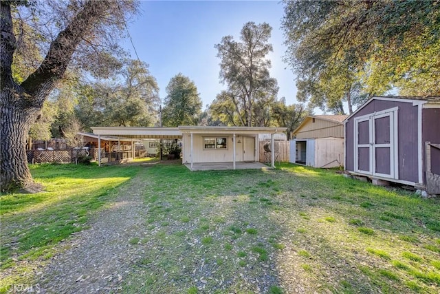 rear view of house with a shed, a yard, and a patio area