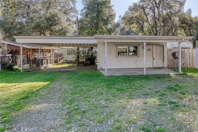 rear view of property featuring a lawn