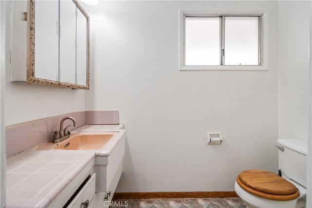 bathroom with vanity and toilet