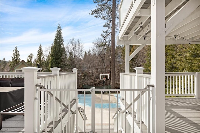 view of swimming pool with a wooden deck