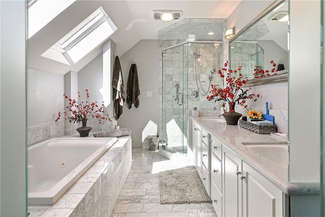 bathroom with vanity, lofted ceiling with skylight, and separate shower and tub