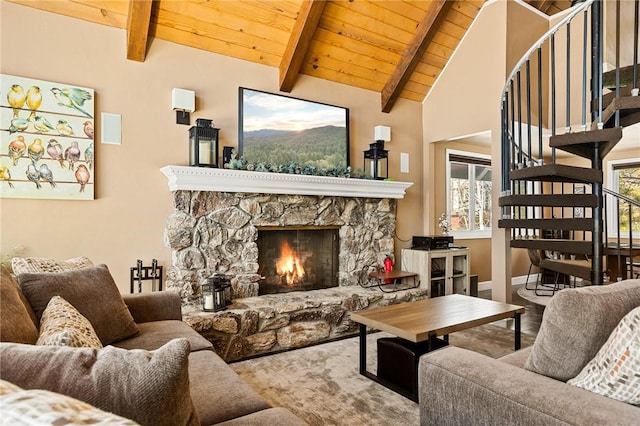 living room featuring wood ceiling, a stone fireplace, lofted ceiling with beams, and plenty of natural light