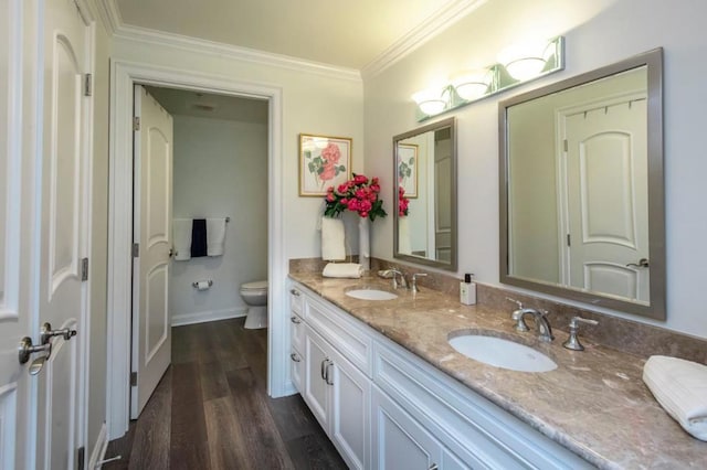 bathroom with ornamental molding, hardwood / wood-style floors, vanity, and toilet