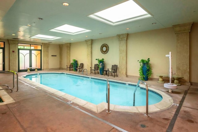 view of swimming pool featuring a skylight