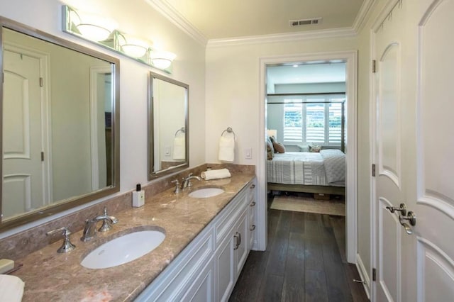 bathroom featuring vanity, hardwood / wood-style floors, and ornamental molding