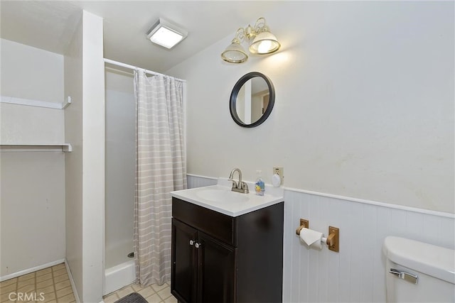 bathroom with tile patterned flooring, vanity, toilet, and a shower with shower curtain