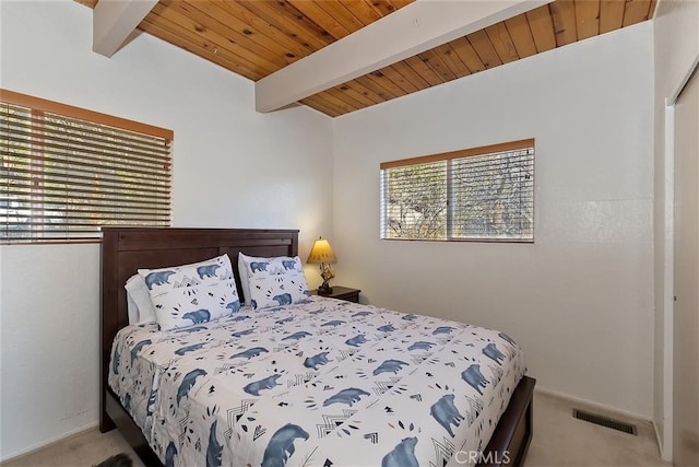 bedroom featuring carpet floors, wooden ceiling, and beam ceiling