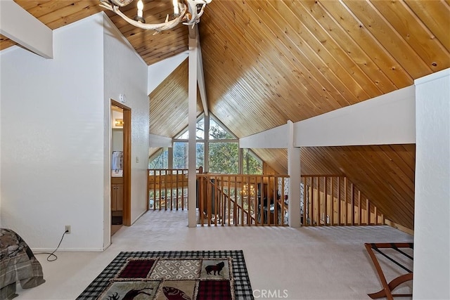 interior space featuring beamed ceiling, light colored carpet, and high vaulted ceiling