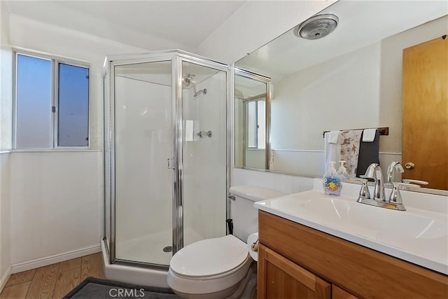 bathroom with a shower with door, wood-type flooring, vanity, and toilet