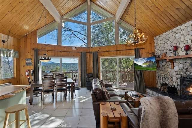 tiled living room with wooden walls, beam ceiling, high vaulted ceiling, and a wealth of natural light