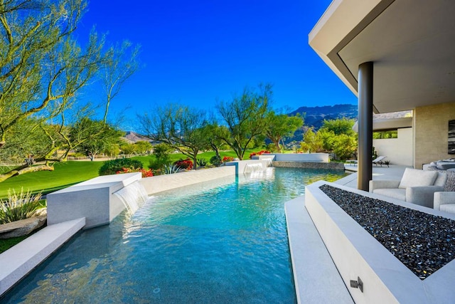 view of swimming pool with a mountain view, a patio area, and pool water feature