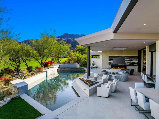 view of swimming pool with a patio area and an outdoor living space with a fire pit