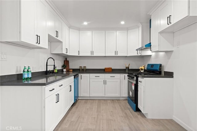 kitchen with sink, light hardwood / wood-style floors, white cabinets, and appliances with stainless steel finishes