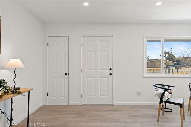 foyer entrance with light hardwood / wood-style flooring