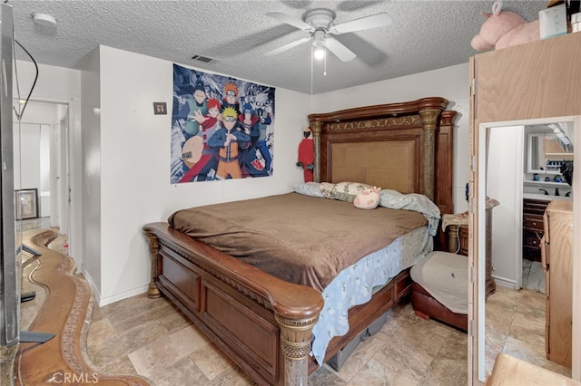 bedroom featuring a textured ceiling and ceiling fan