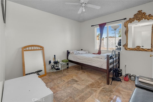 bedroom with a textured ceiling and ceiling fan