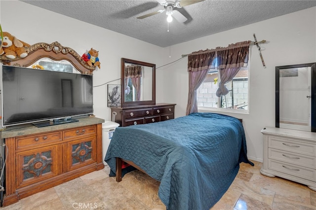 bedroom featuring a textured ceiling and ceiling fan