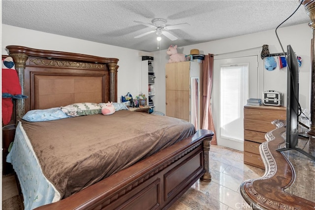 bedroom with a textured ceiling and ceiling fan