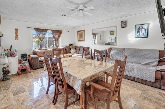 dining room featuring ceiling fan and a textured ceiling