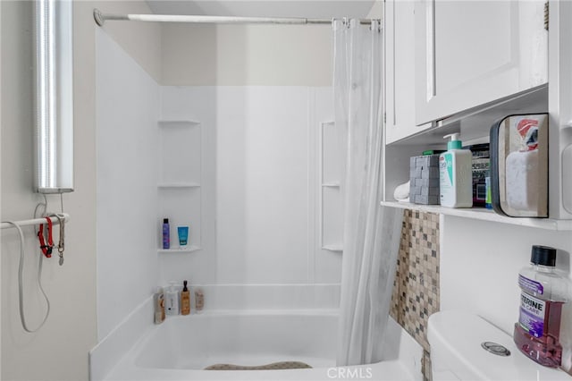 bathroom with toilet and shower / bath combo